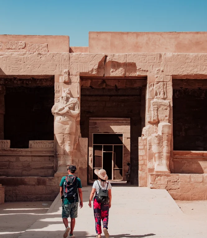 Travelers exploring an Egyptian temple
